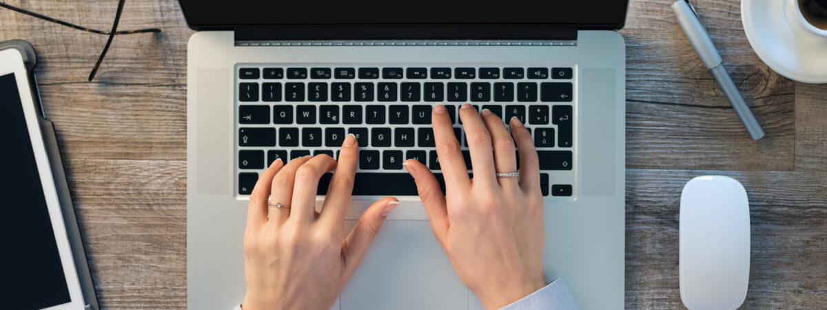 Businesswoman hands typing on laptop